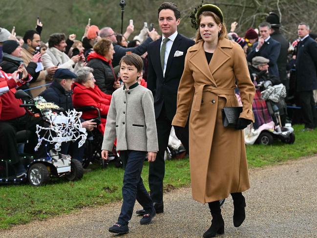 Princess Beatrice and her husband, Edoardo Mapelli Mozzi, walk with his son Christopher Woolf upon arrival to attend the Christmas Day service. Picture: AFP