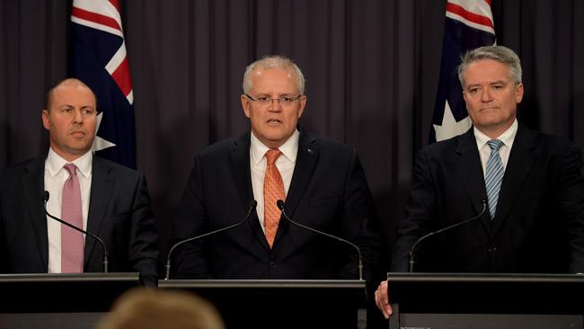 Prime Minister Scott Morrison, centre, with Treasurer Josh Frydenberg, left, and Senator Mathias Cormann, right, in Canberra. Picture: Getty Images