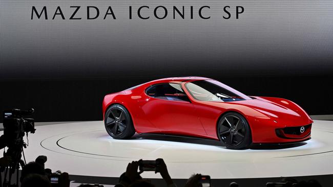 The "Mazda Iconic SP" concept compact sports car is unveiled during the press day of the Japan Mobility Show in Tokyo on October 25, 2023. (Photo by Kazuhiro NOGI / AFP)