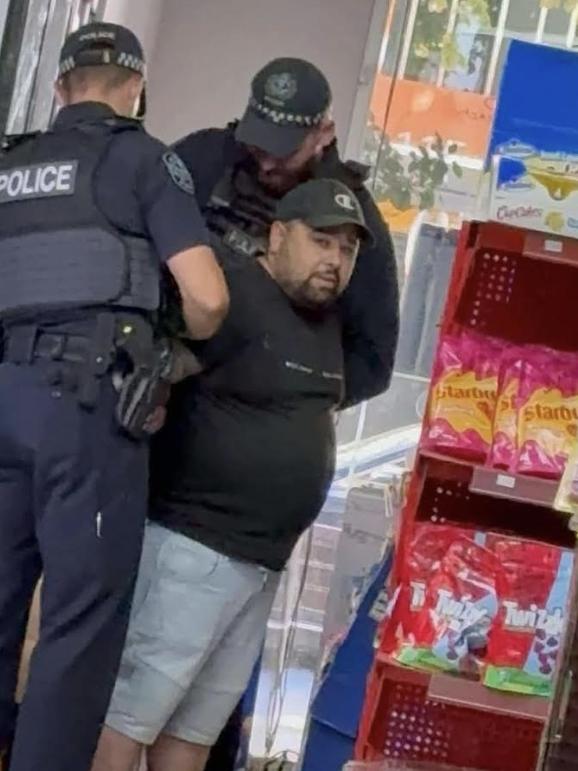 Markus Anthony Blake is arrested inside his lolly shop. Picture: Kayla Stuart / Facebook