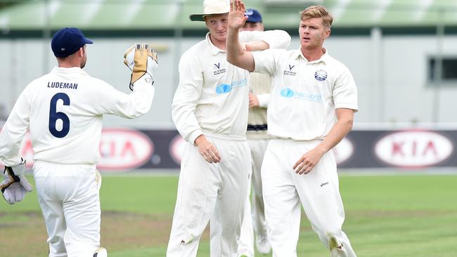 Geelong bowler Dom McGlinchey celebrating a wicket. 