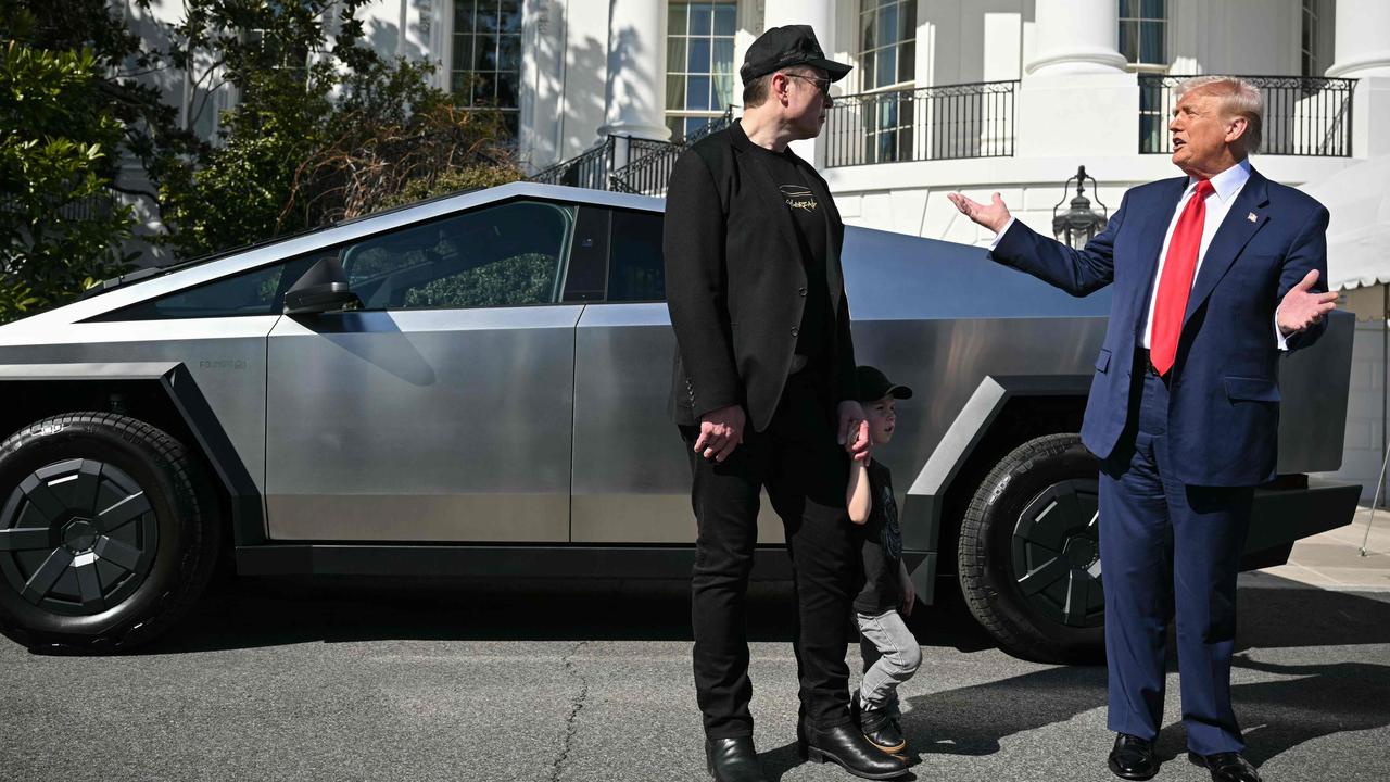 Back in happier times when Donald Trump was helping Elon Musk sell Teslas. (Photo by Mandel NGAN / AFP)