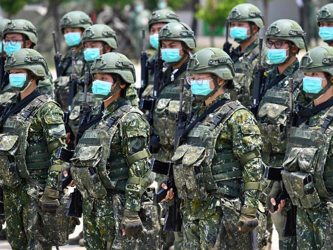 Soldiers wearing face masks amid the COVID-19 coronavirus pandemic listen to an address by Taiwan President Tsai Ing-wen during her visit to a military base in Tainan, southern Taiwan, on April 9, 2020. - Taiwan currently has just 375 confirmed Covid-19 patients and five deaths despite its close proximity and trade links with China where the pandemic began, but the island and its 23 million inhabitants remain locked out of the World Health Organisation (WHO) and other international bodies after Beijing ramped up its campaign to diplomatically isolate Taiwan and pressure it economically and militarily. (Photo by Sam Yeh / AFP)