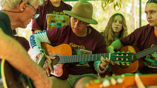 Youth learn to play the guitar at The Youth Forum during the Garma Festival. Picture: Tamati Smith/ Getty Images