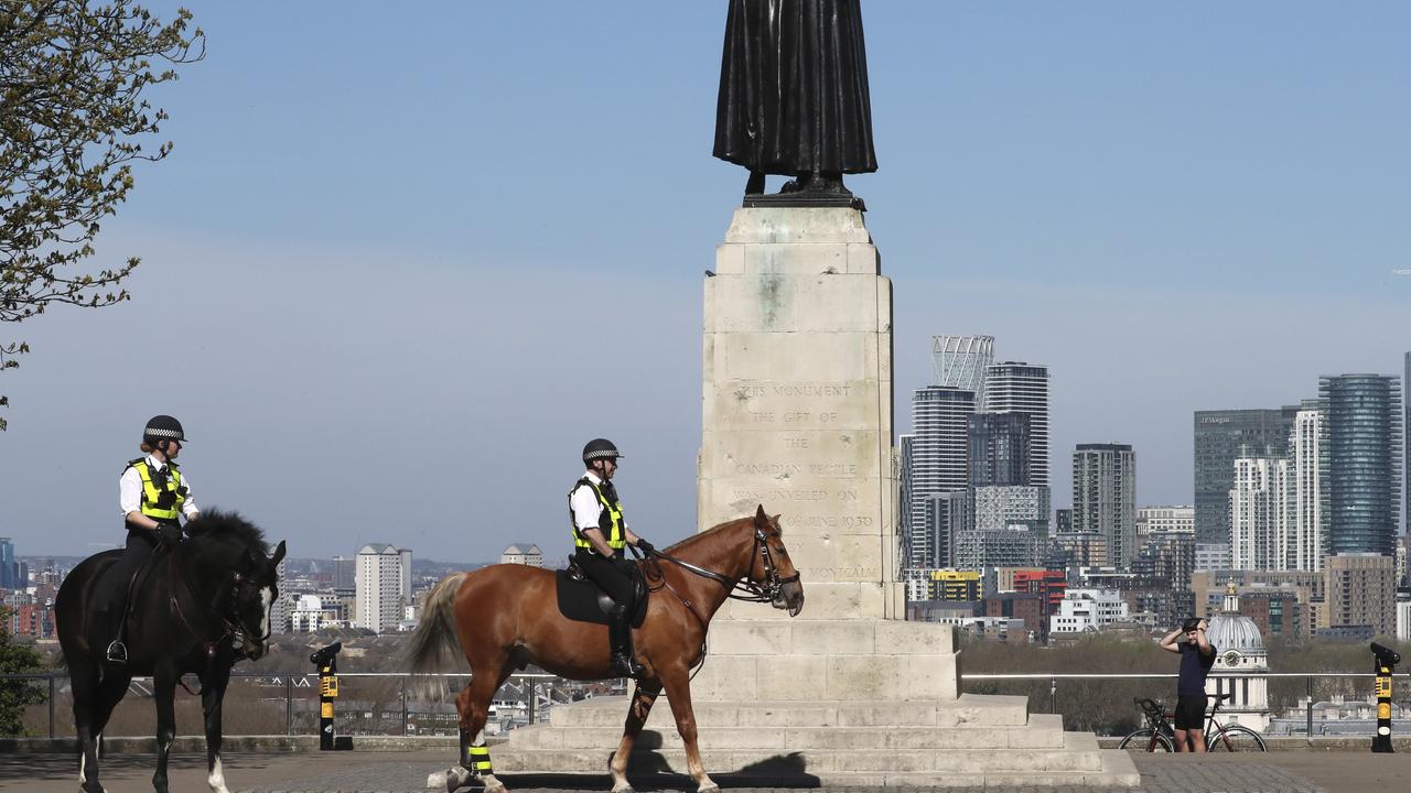 Mounted police patrol near the General Wolfe statue on the upper area of Greenwich Park overlooking the London skyline. Picture: Tony Hicks/AP