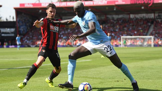 Benjamin Mendy holds off Adam Smith of Bournemouth.