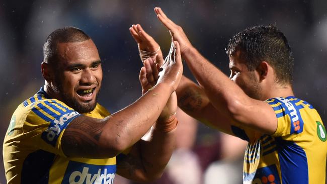 Junior Paulo (left) and Luke Kelly celebrate the Eels upset win.