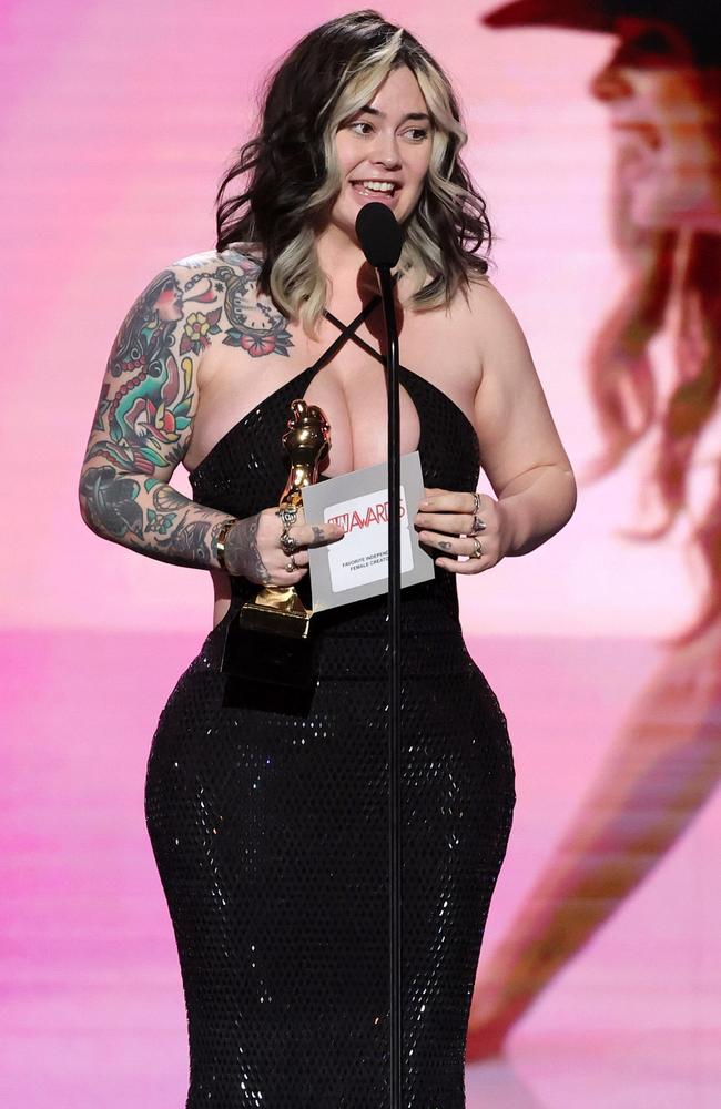 Mama Plugs wore a halter-neck black sequin dress that sparkled under the stage lights as she accepted the award for Independent Female Creator. Picture: Ethan Miller/Getty Images