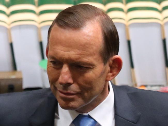 PM Tony Abbott confers with front bench during Question Time in the House of Representatives, Federal Parliament, Canberra.