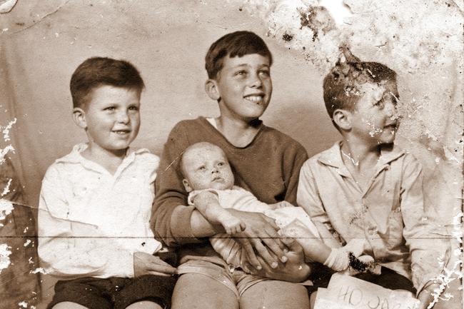 Michael Howard as a baby with his three older brothers, Phil centre, Tim left and Lew right. Picture: Supplied