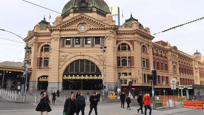 Commuters walk outside the usually bustling Flinders Street station.