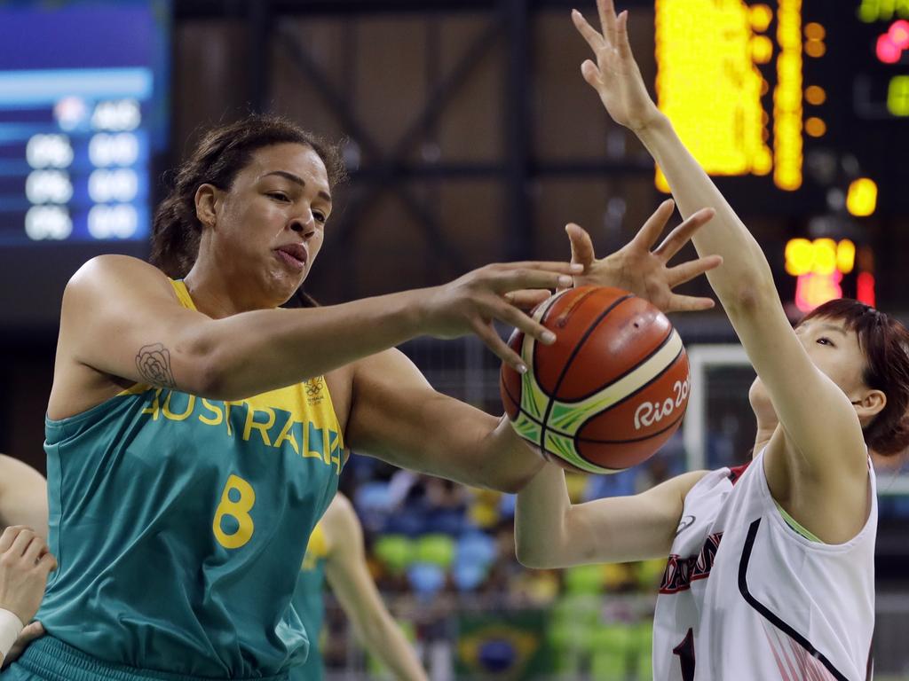 Australia center Liz Cambage (8) reaches for a rebound in front of Japan guard Sanae Motokawa during the first half of a women's basketball game at the Youth Center at the 2016 Summer Olympics in Rio de Janeiro, Brazil, Thursday, Aug. 11, 2016. (AP Photo/Carlos Osorio)