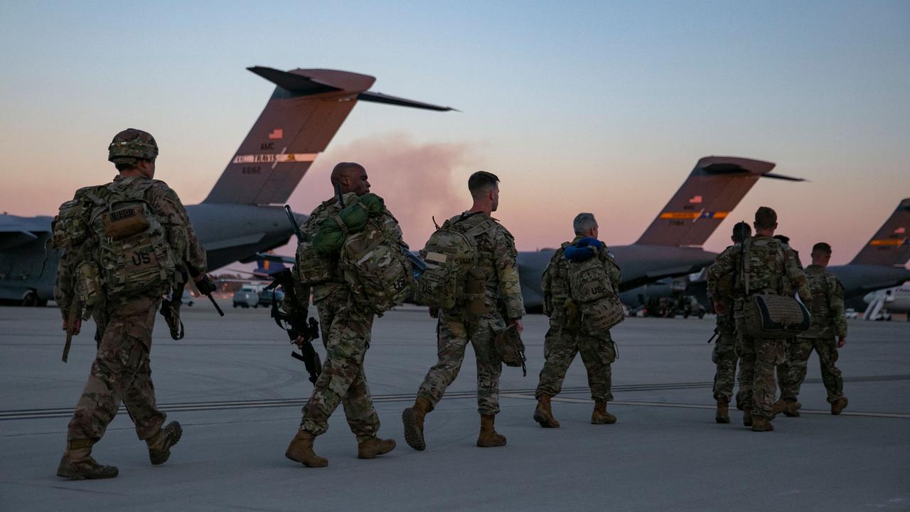 US soldiers walk to board a plane in North Carolina on Monday, preparing to deploy to Europe as the crisis between Russia and Ukraine escalates. Picture: Allison Joyce/AFP