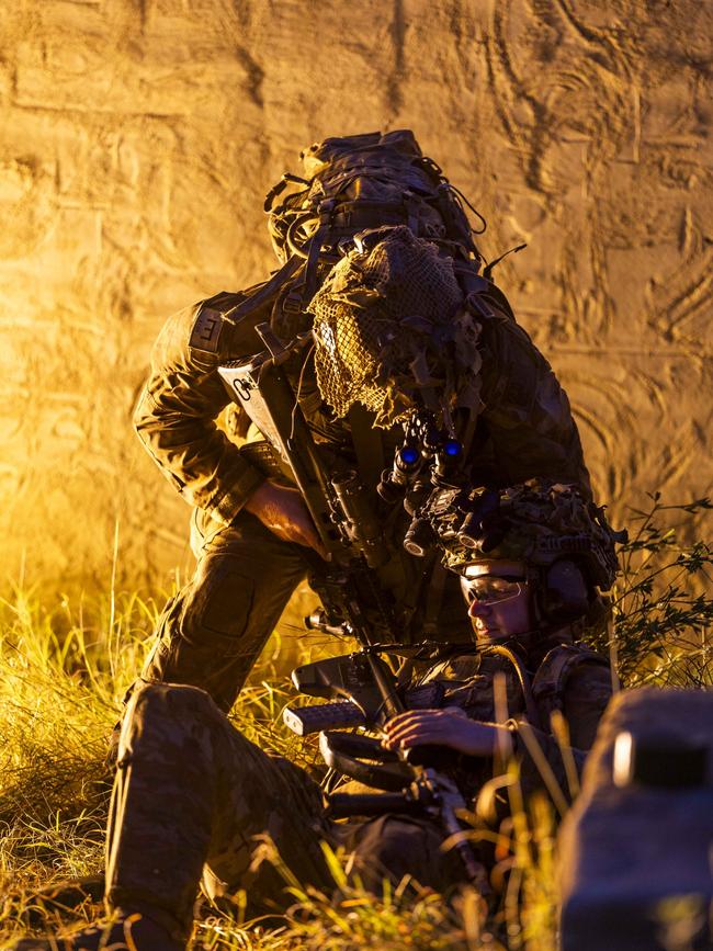 An Australian Army soldier from the 3rd Combat Engineer Regiment assist a simulated casualty during a breaching and detection dog serial at Townsville Field Training Area, Queensland PHOTO: TPR Dana Millington