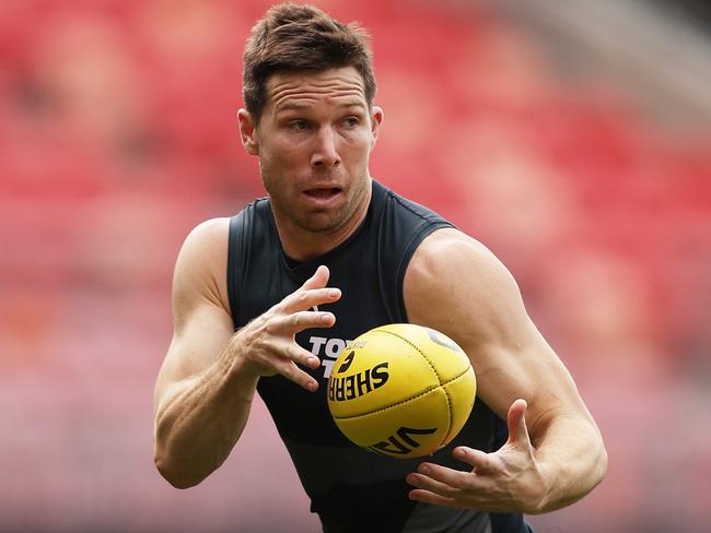 SYDNEY, AUSTRALIA - SEPTEMBER 12:  Toby Greene of the Giants handles the ball during a Greater Western Sydney Giants AFL training session at ENGIE Stadium on September 12, 2024 in Sydney, Australia. (Photo by Matt King/Getty Images)