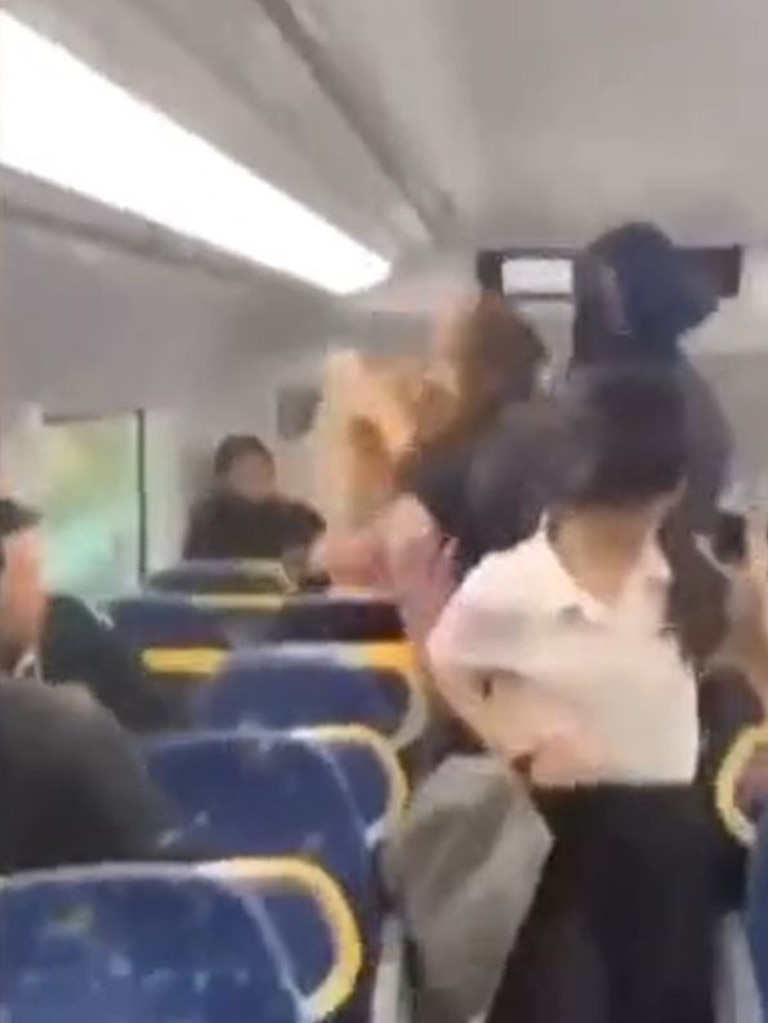 Two teenage girls in school uniform were filmed in a brawl with another train passenger. Picture: 7 News