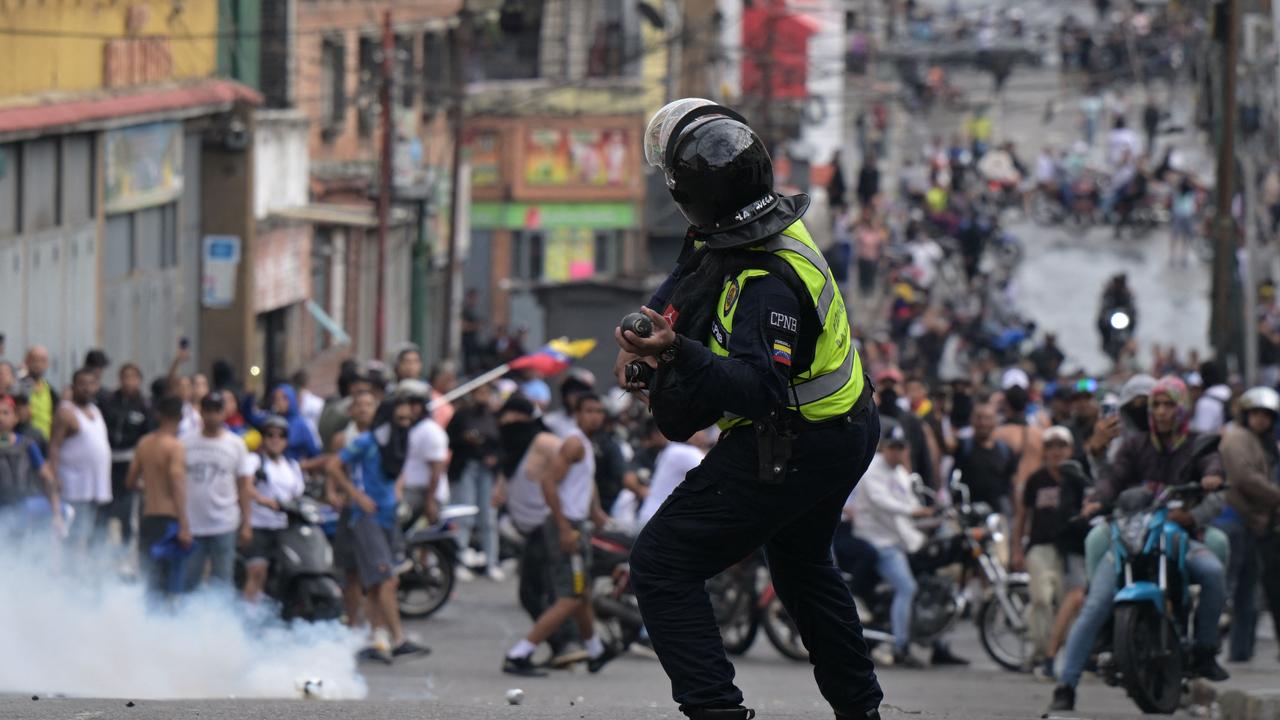 A riot police officer uses tear gas against demonstrators. Picture: Yuri CORTEZ / AFP