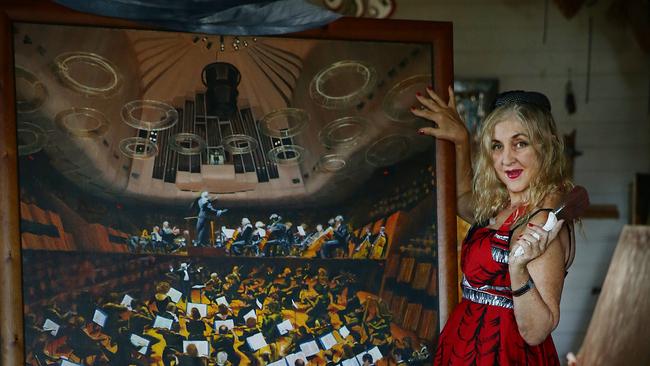 Pinniger with her painting of the 1995 Sydney Symphony Orchestra.