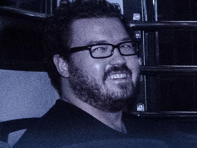 (FILES) This file photo taken on November 10, 2014 shows British banker Rurik Jutting (R), charged with the grisly murders of two Indonesian women, smiling as he sits in a prison van leaving the eastern court in Hong Kong. Jutting pleaded 