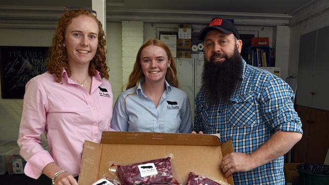 Bonnie and Matilda Penfold and Nat Spary with the Four Daughters donation of meat to The Base Services. Picture: Bev Lacey