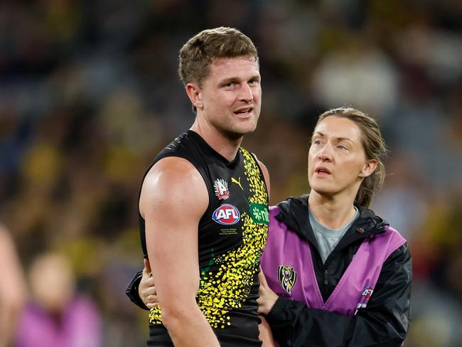 MELBOURNE, AUSTRALIA – APRIL 24: Jacob Hopper of the Tigers is seen to by medical staff during the 2024 AFL Round 07 match between the Richmond Tigers and the Melbourne Demons at the Melbourne Cricket Ground on April 24, 2024 in Melbourne, Australia. (Photo by Dylan Burns/AFL Photos via Getty Images)