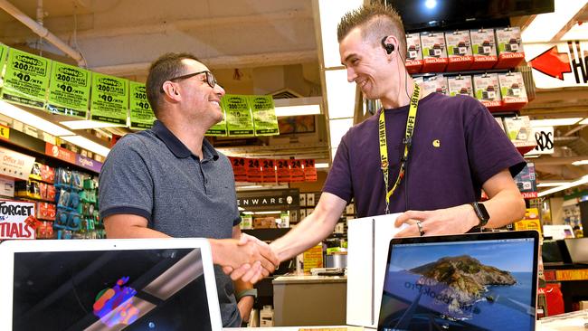 Customer Julian Anastasia from Aspley gets a helping hand from JB Hi Fi staff member Marty Meynell at the Brisbane city JB Hi Fi store. Picture: AAP image, John Gass.