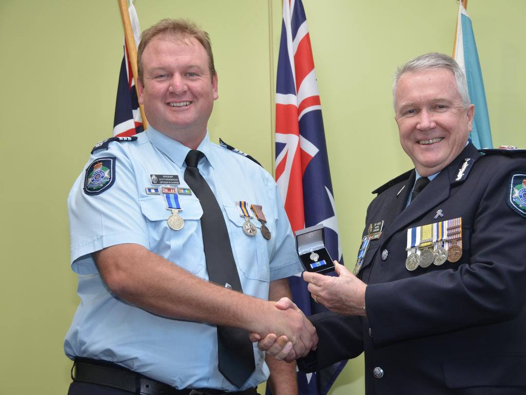 Detective Sergeant Scott Prendergast (left) from Cherbourg accepts the Queensland Police Service Medal (3rd Clasp) for 25 years service.