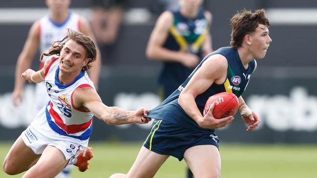 MELBOURNE, AUSTRALIA - APRIL 27: Finn O'Sullivan of the AFL Academy is tackled by Caleb Poulter of the Bulldogs during the 2024 AFL Academy match between the Marsh AFL National Academy Boys and Footscray Bulldogs at Whitten Oval on April 27, 2024 in Melbourne, Australia. (Photo by Michael Willson/AFL Photos via Getty Images)