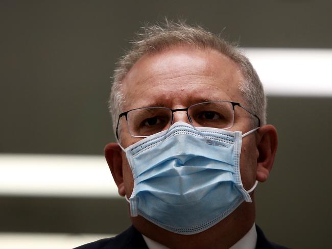 SYDNEY, AUSTRALIA - AUGUST 19: Prime Minister Scott Morrison is seen wearing a face mask during a press conference at AstraZeneca on August 19, 2020 in Sydney, Australia.  The Australian government has announced an agreement with the British pharmaceutical giant AstraZeneca to secure at least 25 million doses of a COVID-19 vaccine if it passes clinical trials.  The University of Oxford COVID-19 vaccine is currently in phase-three testing. If the vaccine proves to be successful, Australia will manufacture and supply vaccines and will be made available for free. The project could deliver the first vaccines by the end of this year or by early 2021. (Photo by Lisa Maree Williams/Getty Images)