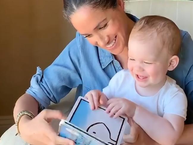 Meghan, the Duchess of Sussex, reads to her son Archie on his first birthday. Picture: Duke and Duchess of Sussex/AFP/Save The Children