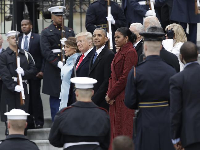 Former President Barack Obama and his wife Michelle stand with President Donald Trump and first lady Melania Trump during a departure ceremony on the East Front of the U.S. Capitol in Washington on January 20, 2017, after Trump was inaugurated. Picture: AP