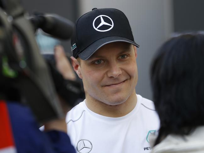 Mercedes driver Valtteri Bottas of Finland talks to journalist at the paddock during a Formula One pre-season testing session at the Catalunya racetrack in Montmelo, outside Barcelona, Spain, Tuesday, March 7, 2017. (AP Photo/Francisco Seco)