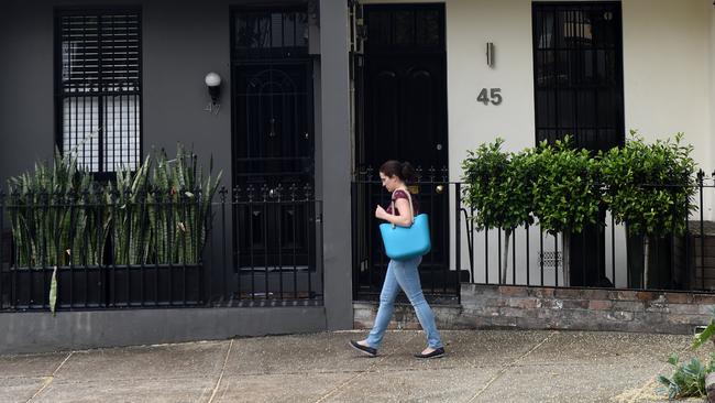 A women walks past some residential houses in Sydney on Wednesday, Oct. 14, 2015. Westpac will raise its variable mortgage rates by 0.20 percentage points to 5.68 per cent on November 20, when residential investment property loan rates will go up by the same amount to 5.95 per cent. (AAP Image/Paul Miller) NO ARCHIVING