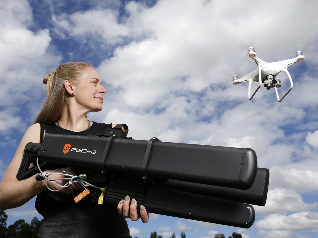 The hefty weapon, pictured here being held by DroneShield CFO Claire Newey, can take down a drone from kilometres away. Picture: DroneShield