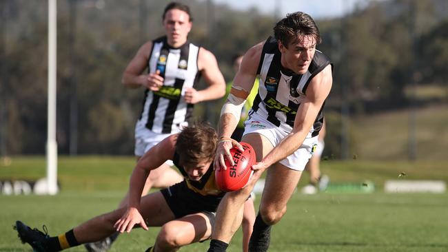 Magpie James Webb break clear in the round 4 TSL match between the Tigers and Glenorchy Magpies from Kingston Twin Ovals. Picture: Zak Simmonds