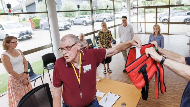 Returning Office for the seat of Aspley Tom Freeman draws the voting ballot order at Carseldine with candidates Fiona Hawkins (Greens), Bart Hellish (ALP) and Amanda Cooper (LNP) present. Picture: Lachie Millard