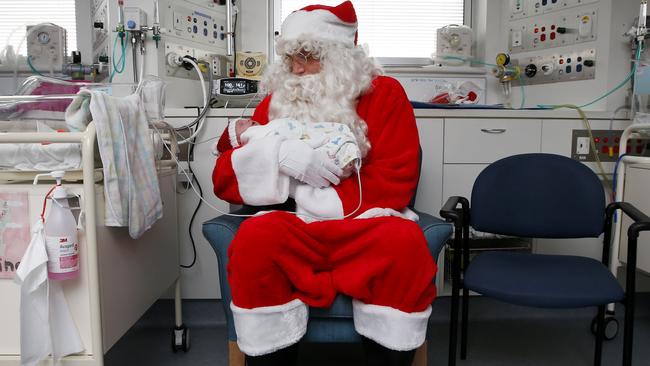 Santa visits NICU babies at The Mercy Hospital. He is nursing nine-day-old Elaina Keiller. Picture: David Caird