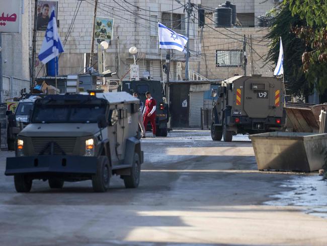 Israeli forces in armoured vehicles conduct a raid in Jenin in the occupied West Bank. Picture: AFP