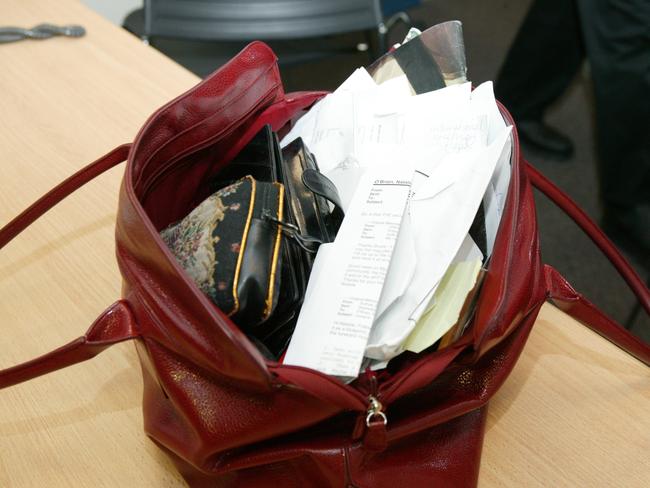 Australian Federal Police raid the offices of The Australian Newspaper and go through Natalie O’Brien’s handbag. Picture: John Fotiadis