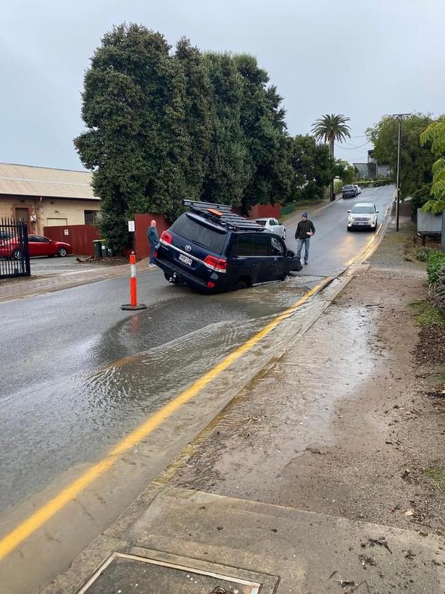 A car became trapped in a flooded hole at Port Noarlunga. Picture: Michelle Elizabeth