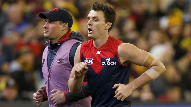 Jake Lever limps off the ground. Picture: Getty Images