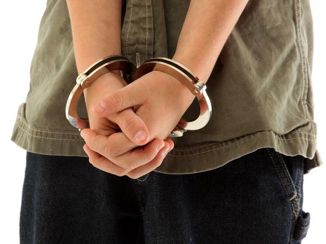 Child's hands handcuffed, juvenile crime.