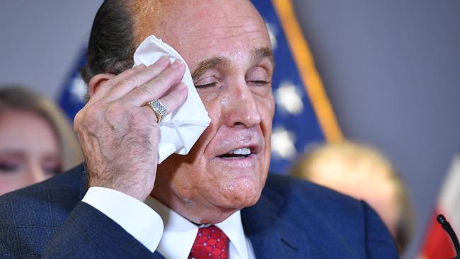 Trump's personal lawyer Rudy Giuliani wipes it a way. Picture: AFP