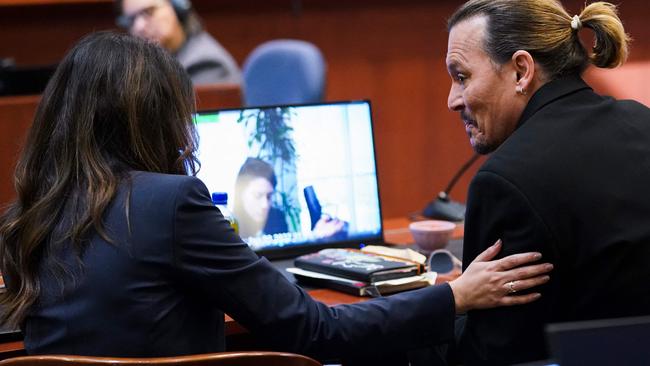 Another day in court, and more touching between the pair. Picture: Kevin Lamarque/AFP