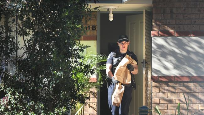 Police and detectives remove evidence from the scene. Picture: Dean Martin