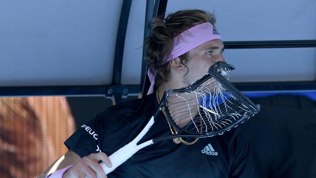 Zverev with the destroyed racquet. Picture: Andy Brownbill/AP