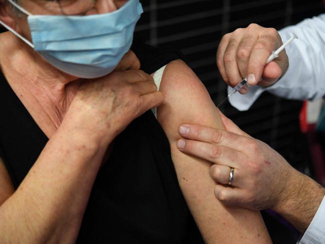 (FILES) In this file photo taken on March 02, 2021 an elderly woman receives a dose of the Pfizer-BioNtech Covid-19 vaccine, at a vaccination centre in Garlan, western France. - The EU's health and medicine agencies said on July 11, 2022 they were recommending a second booster shot of a Covid vaccine for people over 60 years old, as infections rise again. (Photo by Fred TANNEAU / AFP)