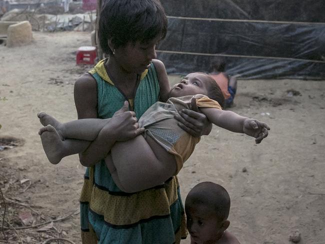 A girl carries a toddler in her arms in Kutapalong Rohingya refugee camp in Bangladesh. Picture: Allison Joyce/Getty Images