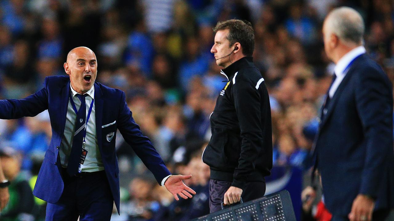 Kevin Muscat, Victory Coach, looks towards Sydney Coach Graham Arnold during the A League Grand Final