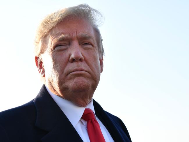 US President Donald Trump speaks with reporters before departing for a rally on October 27, 2018 in Murphysboro, Illinois. (Photo by Nicholas Kamm / AFP)